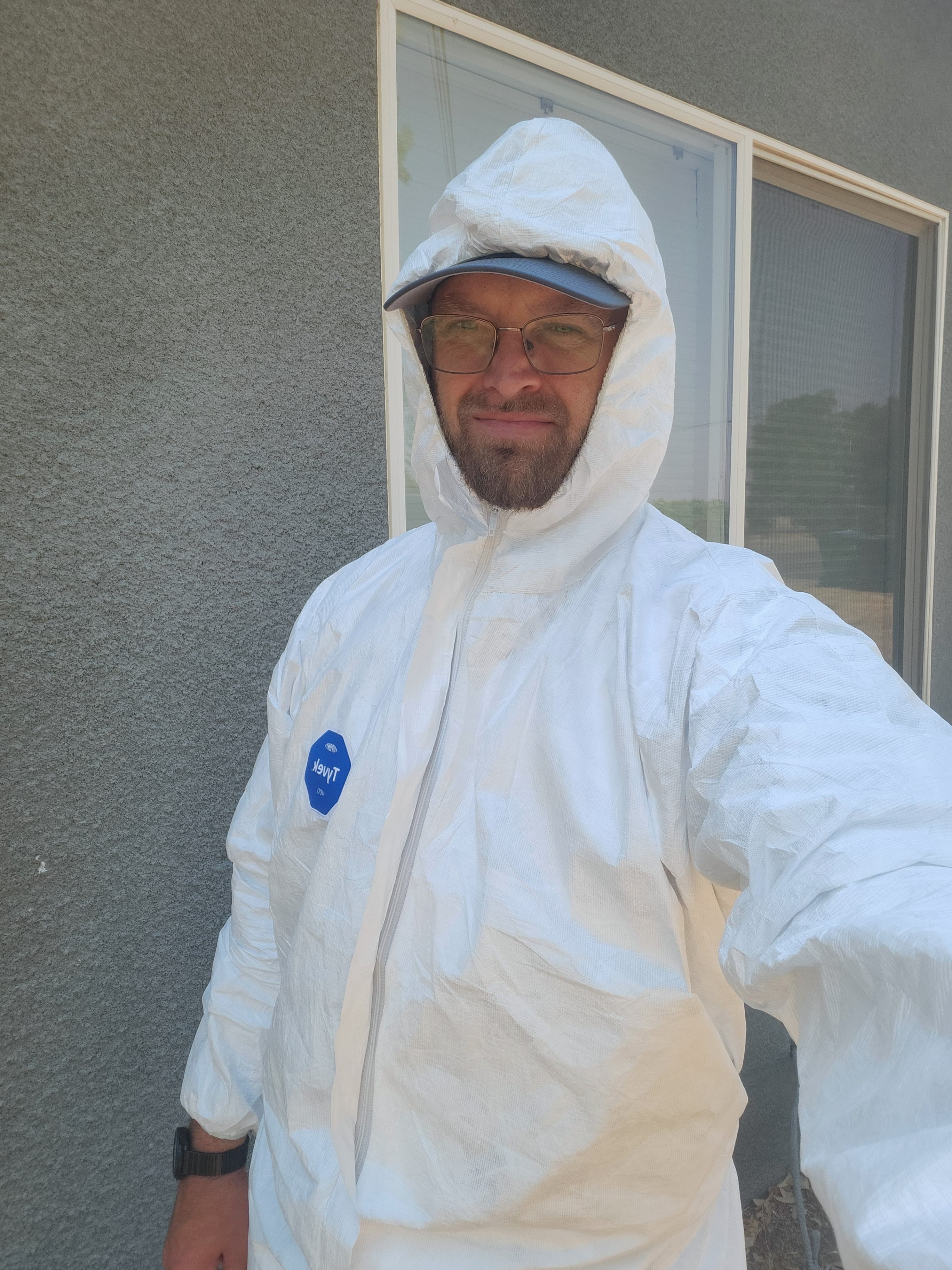 Aaron Husak wearing protective coveralls before heading into a crawlspace
